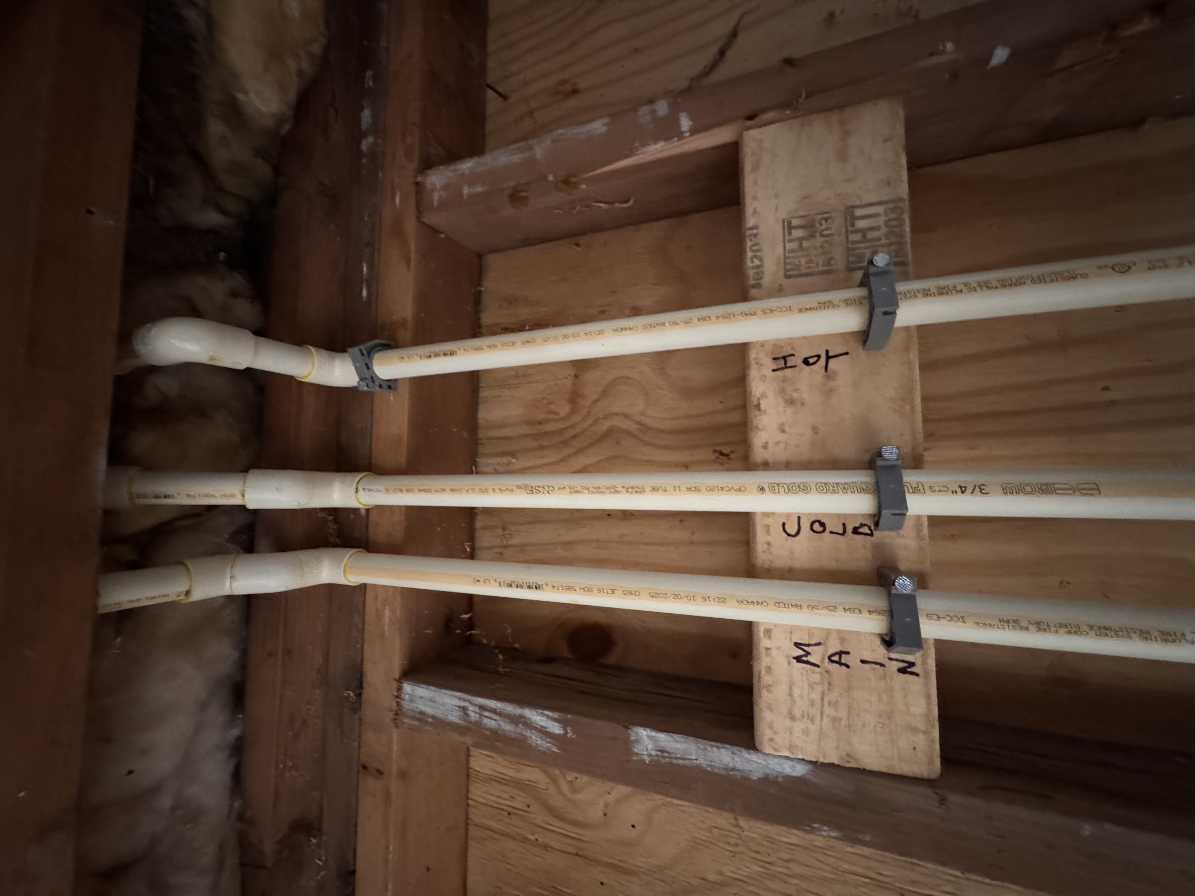 CPVC supply lines labeled main cold hot close-up